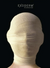 persons face wrapped in white gauze on black background